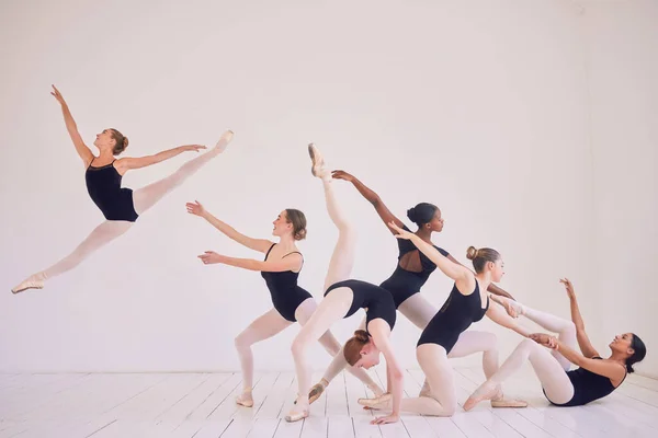 Group of contemporary or ballet dancers performing a unique sequence in a studio. Team of modern elegant ballerinas dancing or practicing for performance and creating entertainment art.