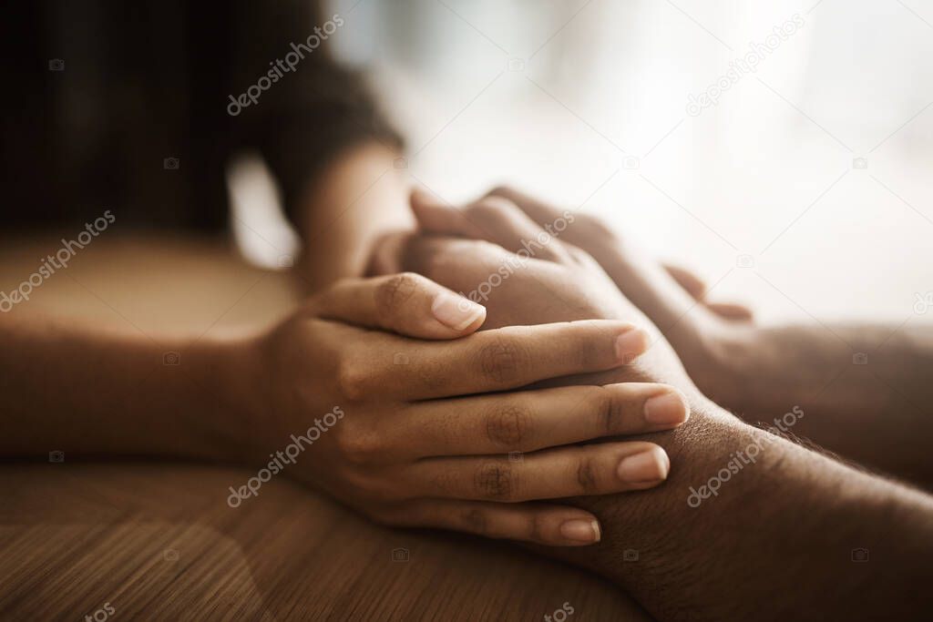 This is a safe place. two unrecognizable people holding hands in comfort