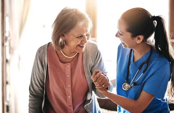 Im here to help you every step of the way. a caregiver assisting a senior patient in a nursing home