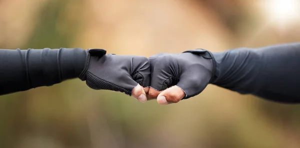 Fist bump, motivation and workout success of fitness friends after sports training in nature. Closeup of a hand gesture doing an exercise goal showing community, support and teamwork collaboration.