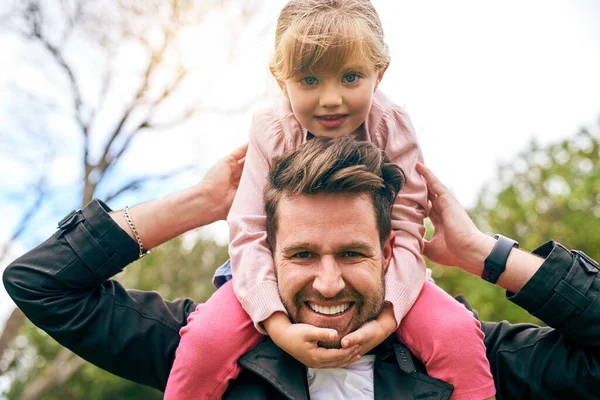 Little girls mean the world to their daddys. a father and daughter bonding outside