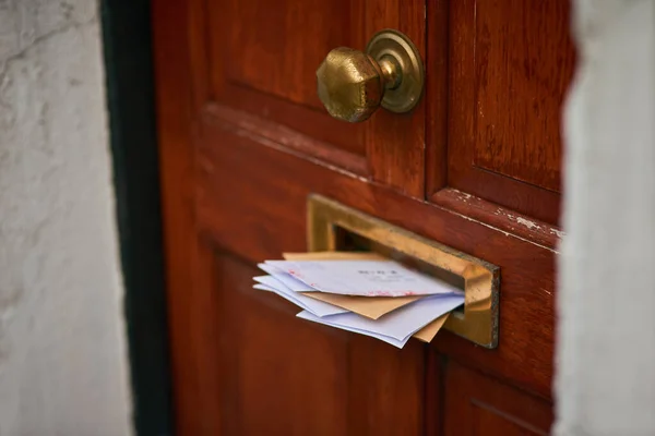 Someone hasnt checked their mail in a while. letters in a letter box