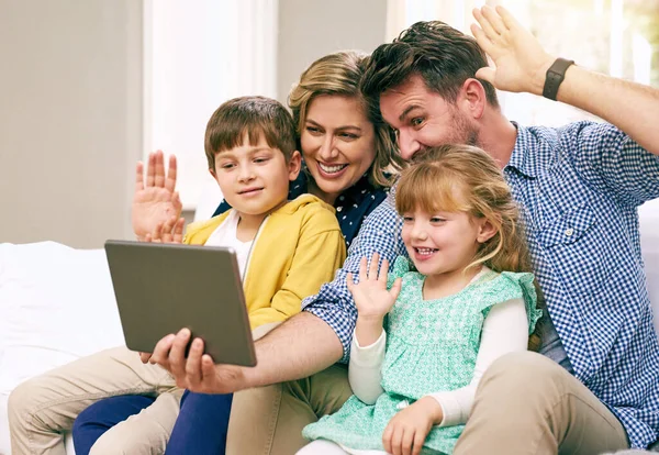 Greetings to our other family members. a family using a tablet together at home