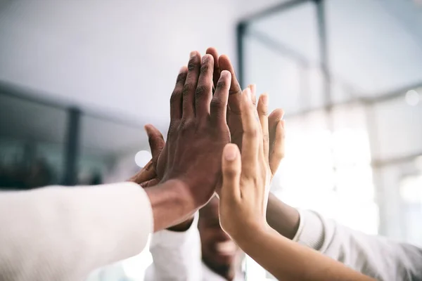 Here we go guys. a motivated group of unrecognizable businesspeoples hands coming together for a high five