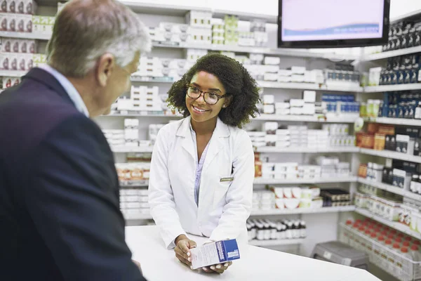 I found what you need. a cheerful young female pharmacist giving a customer prescription meds over the counter in a pharmacy