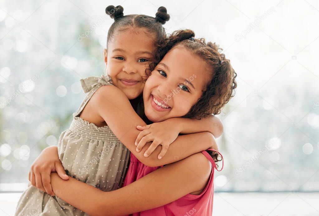 Cute, adorable and sweet girls hugging and bond with a happy and healthy childhood growing at home. Portrait of innocent and loving sisters with a bright smile, affection and relaxing in the house.