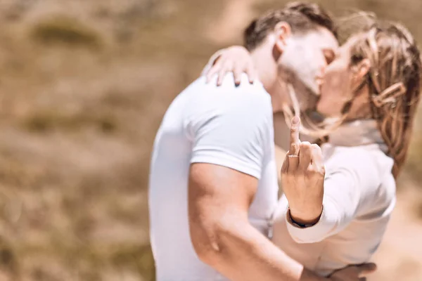Young Woman Showing Her Engagement Ring Finger While Couple Kiss — ストック写真
