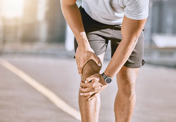 Runner training accident with joint pain, arthritis and tendon problems. Health, fitness and a sports injury with athlete man suffering from a fracture, broken leg and knee after a workout