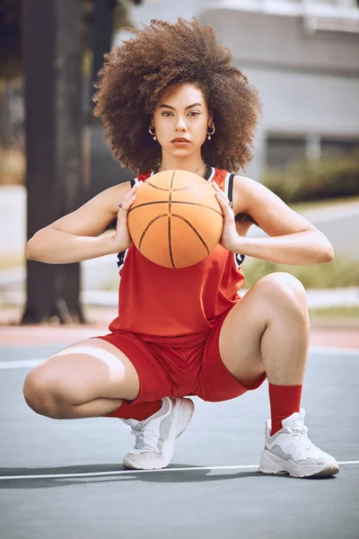 Basketball, training and sport player with a ball ready to start workout, exercise and game. Portrait of a black woman athlete with sports motivation and fitness focus on a outdoors court with beauty.