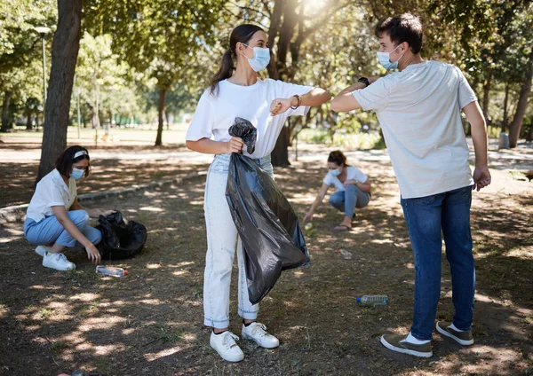 Covid Cleaning Volunteers Wearing Masks While Cleaning Community Park Saying — Zdjęcie stockowe