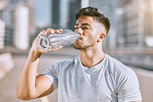 Drinking water, fit and healthy man living an active health, wellness and body or weight watching lifestyle. Athletic running, fitness and sports lover staying cool after workout or training routine.