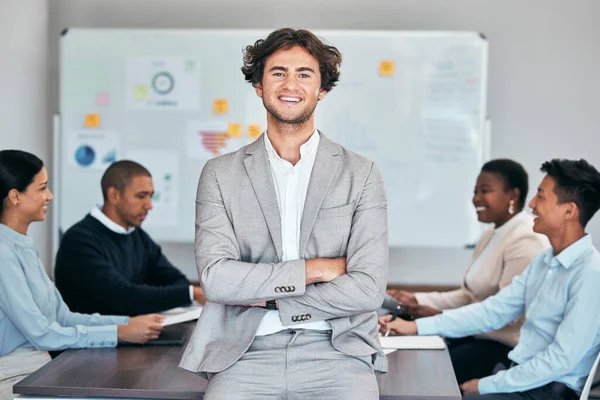 Business man standing with arms crossed in meeting, leading a training workshop and looking proud with colleagues at work. Portrait of a smiling expert manager showing leadership in a seminar.