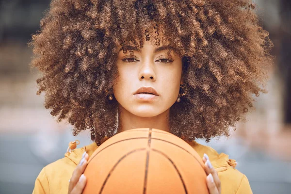 Basketball, sports and motivation with a young, fashion and healthy black woman holding a ball with game, vision and wellness. Portrait of a confident female athlete ready for competition on a court.