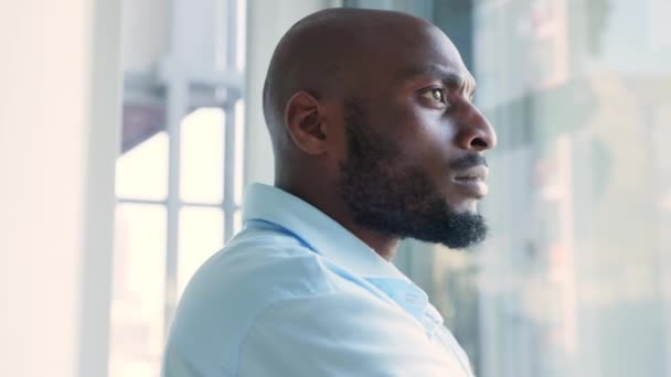 Серьезный Афроамериканский Бизнесмен Думает Стратегии Роста Компании Глядя Окно Молодой — стоковое видео