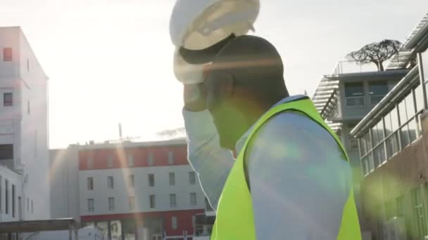 Young Construction Manager Looking Buildings Work Site While Putting Helmet — Vídeo de stock