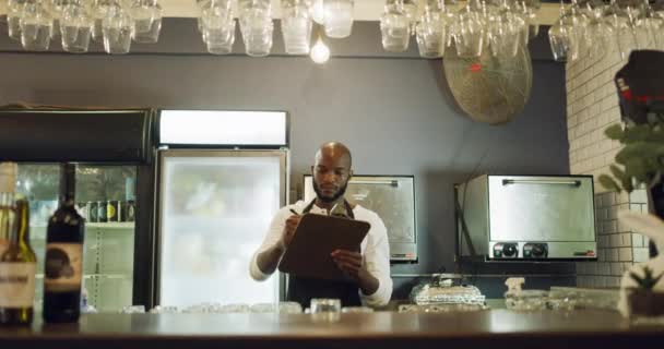 African American Barman Doing Inventory Checklist Counter Restaurant Bar Serious — 图库视频影像