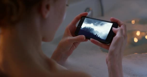 Relaxed Calm Stress Free Woman Bathing Browsing Her Phone While — Vídeo de stock