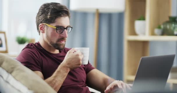 Male Entrepreneur Working Online Computer While Drinking Coffee Sitting Couch — Vídeos de Stock