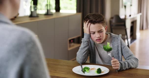 Upset Little Boy Refusing Eat His Broccoli While Sitting Kitchen — Video Stock