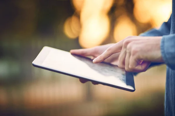 What a great way to be online outdoors. an unrecognizable man using a tablet outdoors