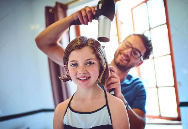 Dads my personal and favourite stylist. a father blowdrying his little daughters hair at home