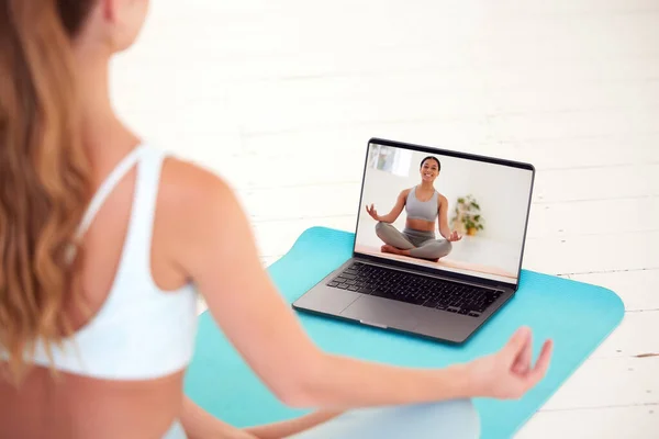 Yoga, meditation and wellness woman watching coach, teacher or professional health and exercise education video or live stream. Girl training and learning how to relax via online classes on a laptop.