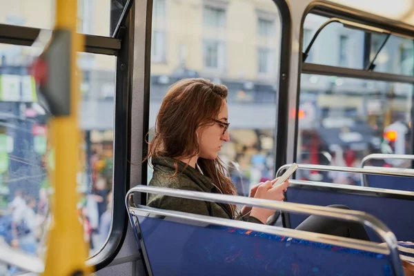 Stay connected while you travel. High angle shot of an attractive young woman listening to music while sitting on a bus