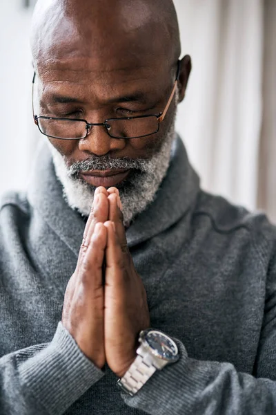 Seeking Guidance Handsome Senior Man Praying While Sitting His Home — Zdjęcie stockowe