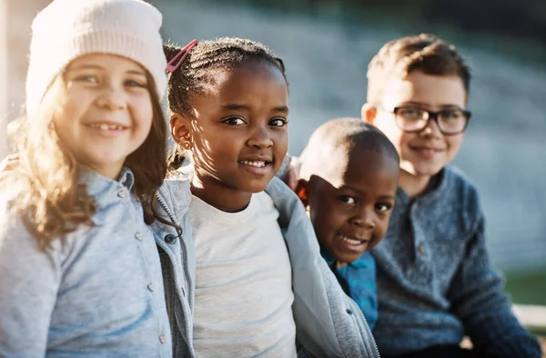 Great friends mean big smiles. Cropped portrait of a group of elementary school kids smiling outside