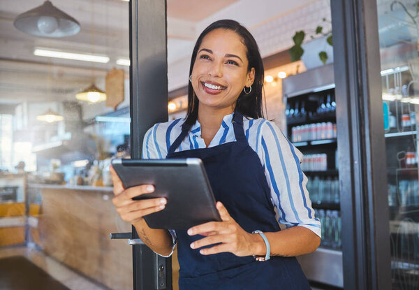 Startup, cafe and business woman in management with smile working on a digital tablet at the store. Manager, coffee shop owner or worker of a small business at work in retail with technology