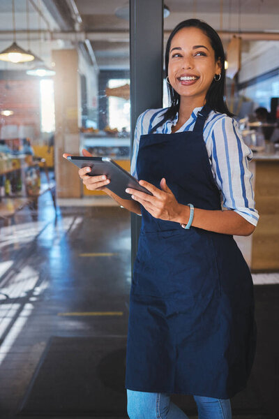 Startup, management and cafe owner online order on digital tablet doing inventory, happy and checking stock. Smiling woman enjoying her job, looking proud and ambitious at a new small business.