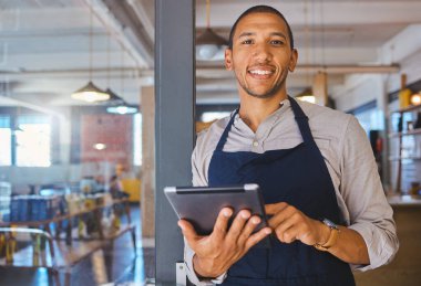 Restaurant entrepreneur with tablet, leaning on door and open to customers portrait. Owner, manager or employee of a startup fast food store, cafe or coffee shop business standing happy with a smile.