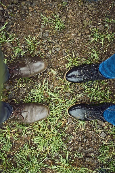 You have some big shoes to fill. two unrecognizable peoples shoes standing next to each other on a patch of grass outside during the day