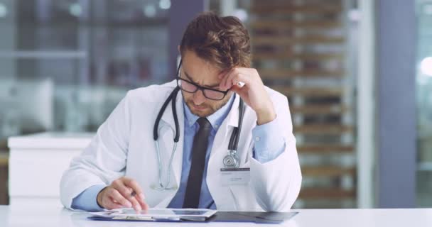 Serious Concerned Confused Medical Healthcare Doctor Revising Patients Records Tablet — Wideo stockowe