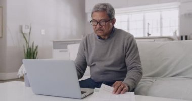 Anxiety, stress and debt by mature man checking finance on a laptop at home. Worried senior male feeling pressure, concerned about budget and financial planning. Older guy stressed about retirement.