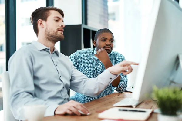 Collaboration will always get you what you need. two designers discussing something on a computer