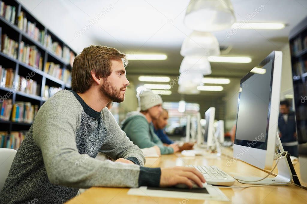 Everyone is studying during exam season. a young male university student studying in the library