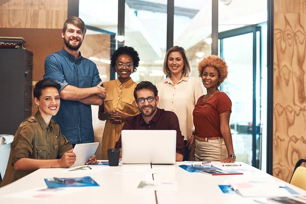 Its an office packed with creative minds. Portrait of a diverse group of businesspeople working together in an office