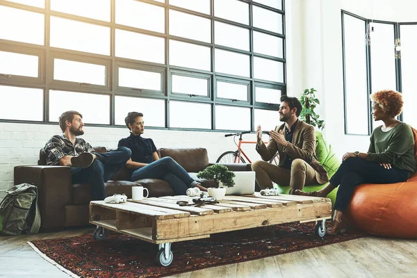 Open your mind and think differently. a group of young designers having a discussion in a modern office