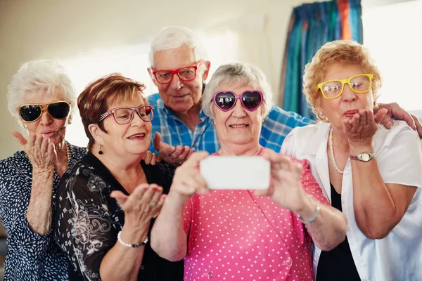 Dont worry about getting old, worry about thinking old. a group of seniors taking a selfie indoors