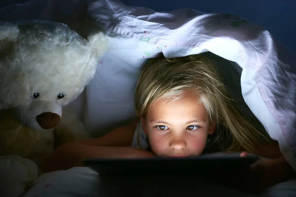 Entertained All Night Long Little Girl Using Digital Tablet Blanket — Zdjęcie stockowe