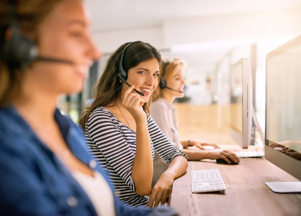 Weve got you covered. Cropped portrait of a young woman working alongside her colleagues in a call center