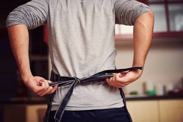 Lets Get Cooking Rearview Shot Unidentifiable Young Man Tying His — Fotografia de Stock