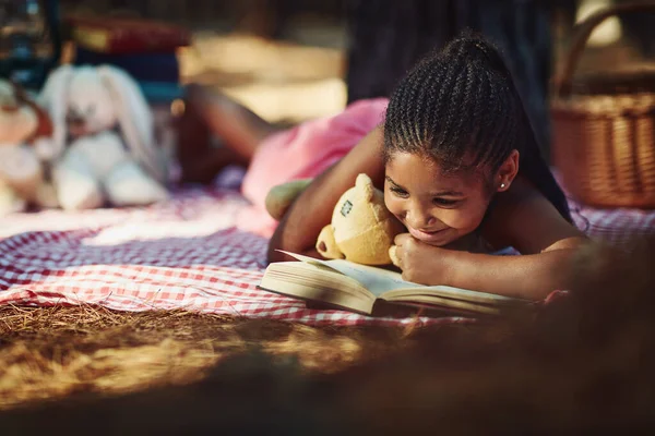 Nurturing Her Imagination Nature Little Girl Reading Book Her Toys — Stockfoto