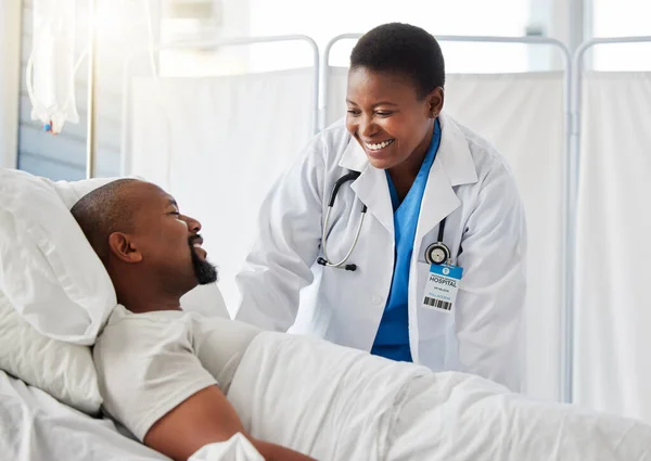 Healthcare doctor, insurance, and patient in bed talking of medical health surgery in hospital or clinic. Trust, care and help checkup by a happy, woman cardiologist worker consulting a sick person.