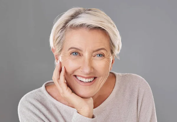 Skincare, beauty and happy senior woman or face model with healthy teeth giving a smile on a headshot studio portrait. Dental, wellness and cosmetic surgery for elderly women to stay beautiful.
