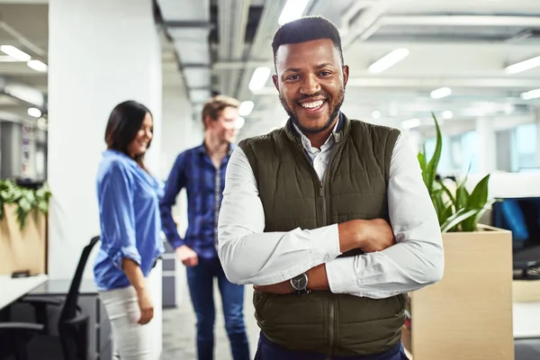 Ive been so successful in this company. Portrait of a young designer standing in an office with his colleagues in the background