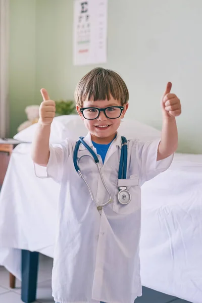 I see doctors as role models. an adorable little boy dressed as a doctor