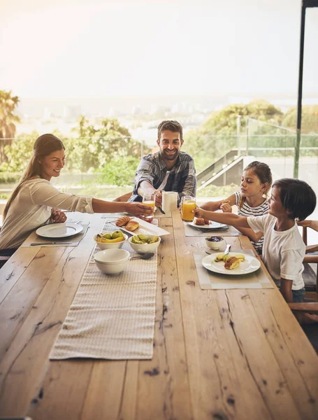 Time to dig in and enjoy a hearty breakfast together. a family having breakfast together at home