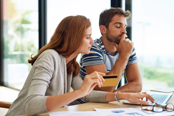 He has to think about this one...a young couple working on their household budget and paying bills online